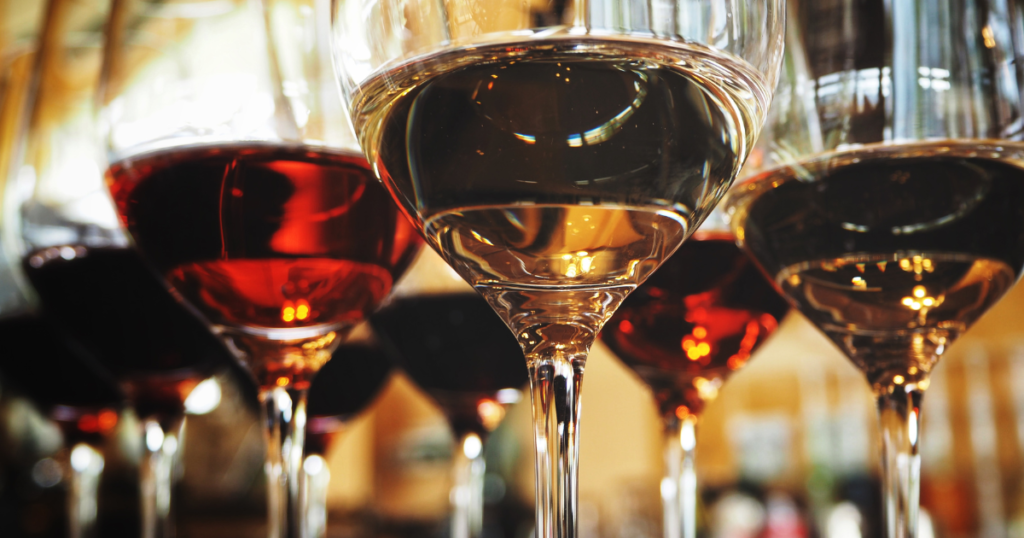 Close-up of red and white wine glasses in a tasting setting
