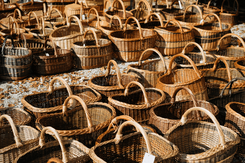 Display of woven wicker baskets in various sizes arranged outdoors.